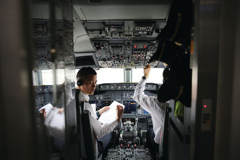 China Southern Airlines Pilot Li Han (left), who has clocked more than 12,000 flight hours, conducts pre-flight checks with his co-pilot