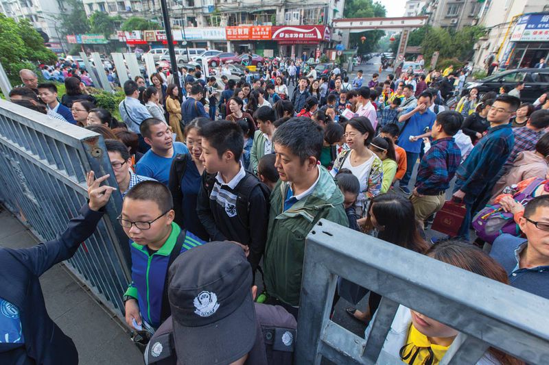 Parents queue with children outside a private school in Hangzhou in May, what may be their last opportunity to attend a good school