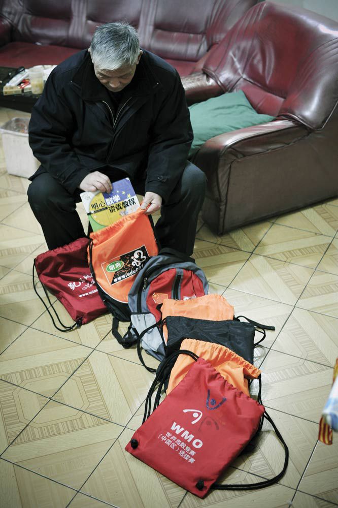 A grandfather packs up one of his grandchild&#x27;s seven after-school enrichment textbooks